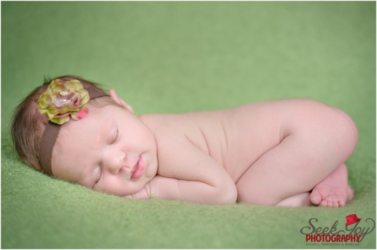 newborn girl smiling with flower headband