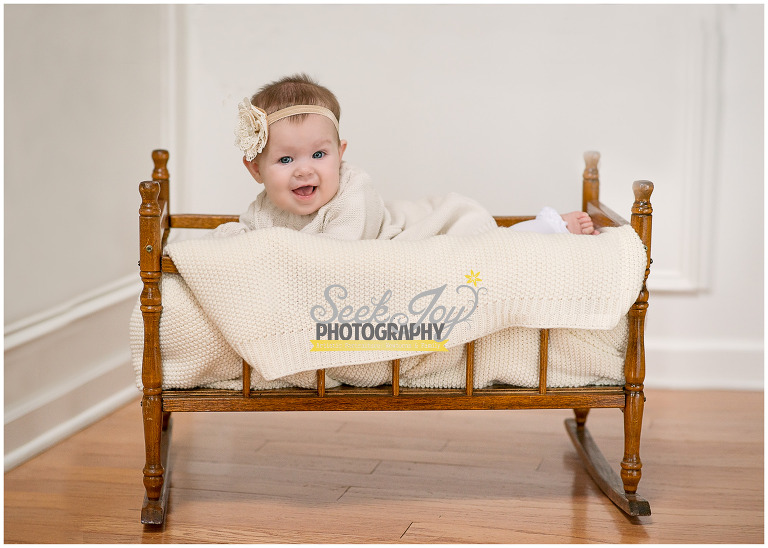 baby girl in vintage cradle